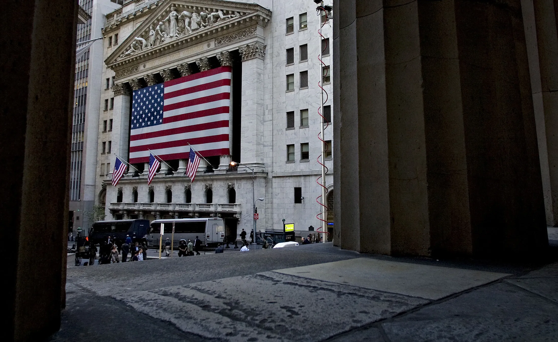 The U.S. flag hangs on the exterior of the New York Stock Exchange.
