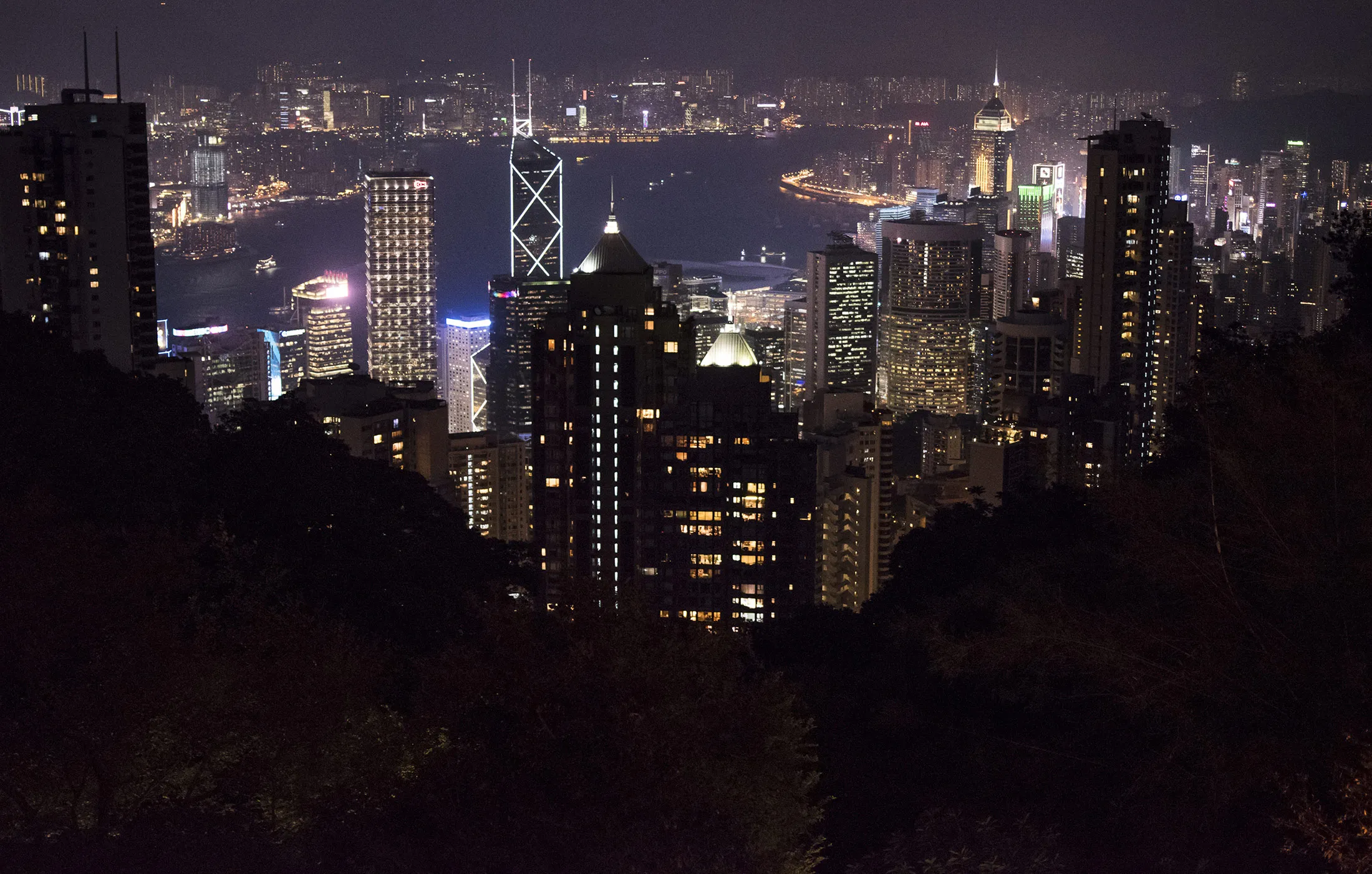 Residential and commercial buildings stand illuminated at night in Hong Kong, China on Friday, Nov. 27, 2015. Secondary private residential property prices dropped 3.9 percent since peaking in September, according to an index published by broker Centaline Property Agency Ltd.
