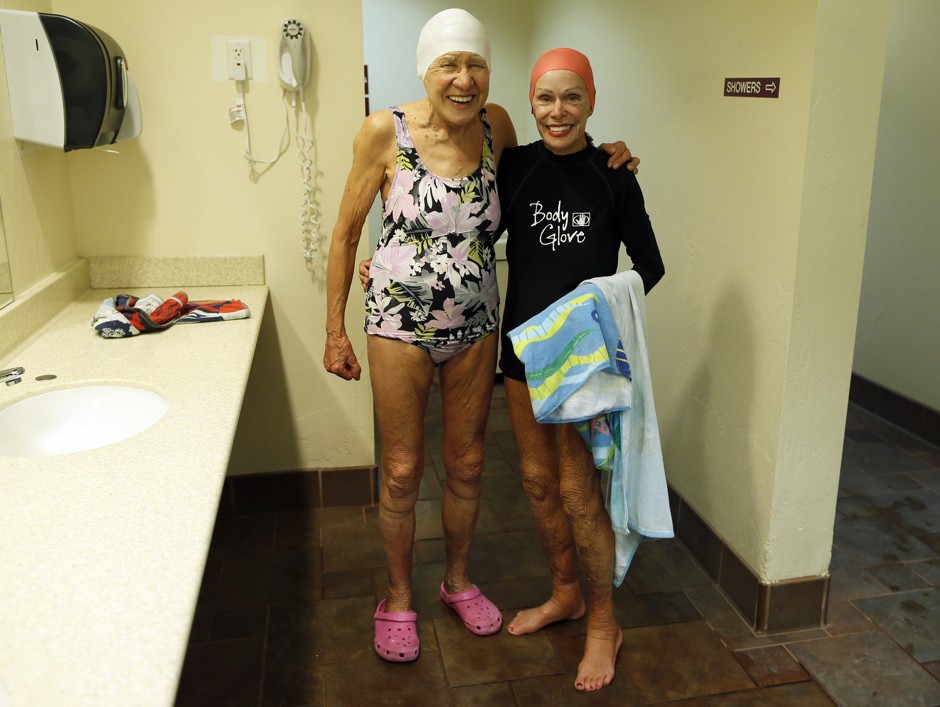 Teodora Spanjers, 80, (L) poses with Ginny Bravos, 86, in a swimming pool locker room in Sun City, Arizona.