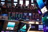 Guests use mobile devices to photograph the floor of the New York Stock Exchange (NYSE) in New York, U.S., on Friday, June 15, 2018. U.S. stocks fell and bonds surged as President Donald Trump moved the country closer to a trade war with China, while investors weighed diverging monetary policies from the Federal Reserve and European Central Bank.