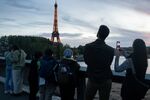 Visitors look towards the illuminated Eiffel Tower on Oct. 18.