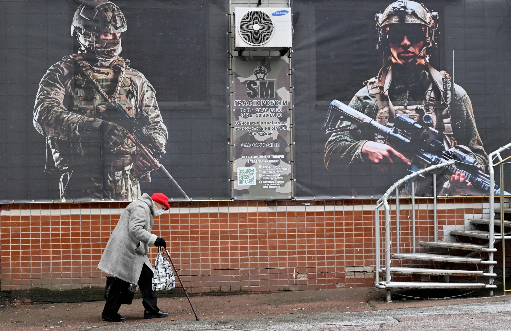 An elderly woman walks past shop windows in Ukraine on&nbsp;January 6.&nbsp;