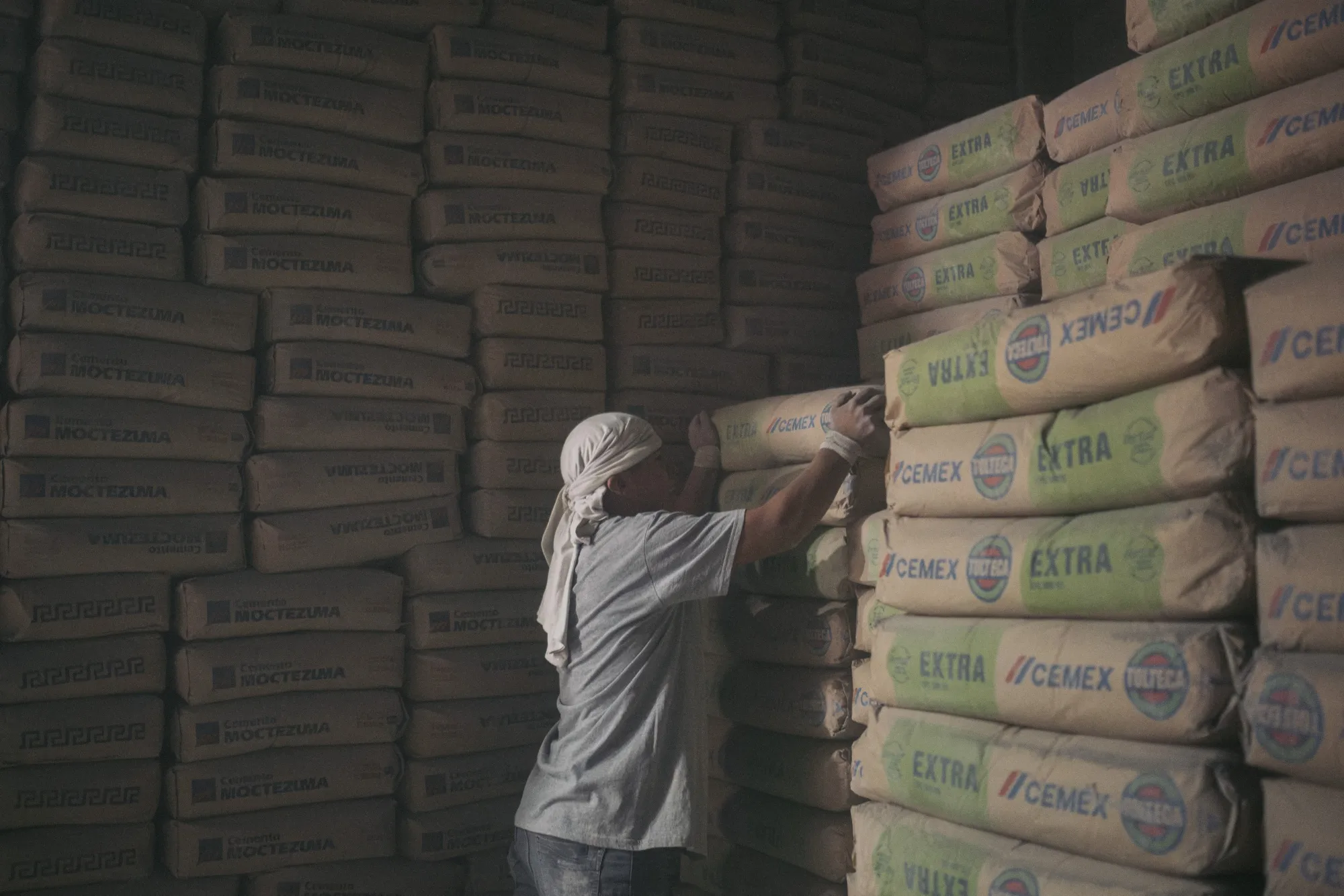 A worker stacks Cemex cement bags at a wholesale warehouse in Mexico City, Mexico, on Thursday, Feb. 8, 2024.&nbsp;