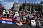 Demonstrators&nbsp;sit in Parliament Square during a climate change protest in London, on July 23.