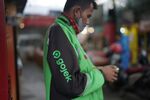 A Gojek driver checks his mobile phone in Jakarta.