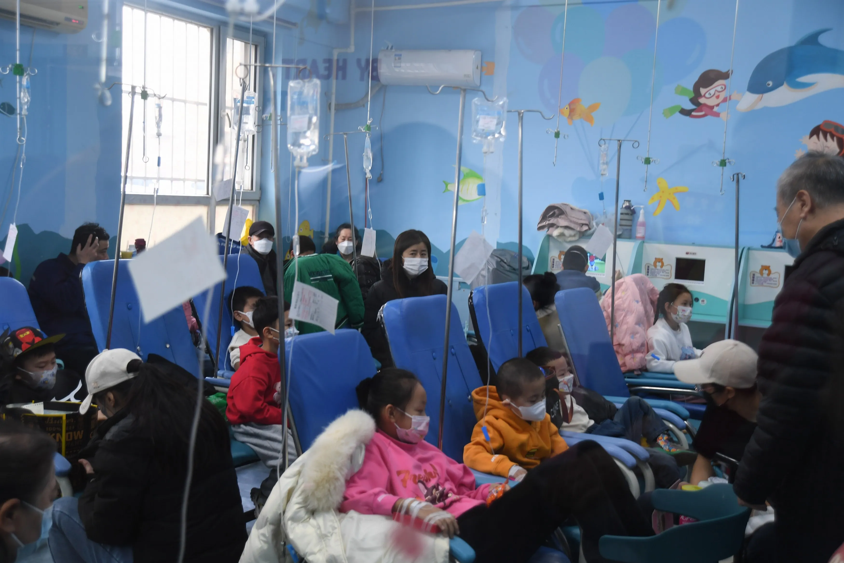 Parents take their children for infusion treatment at a hospital in Shenyang, Liaoning province on Dec. 8.