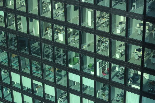 Empty offices in the Omniturm skyscraper in the financial district in Frankfurt, Germany, on Thursday, Feb. 11, 2021. While executives have expressed concern that it will be difficult to maintain a corporate culture if more people work from home, they also stand to reap cost savings from renting less office space in financial centers.