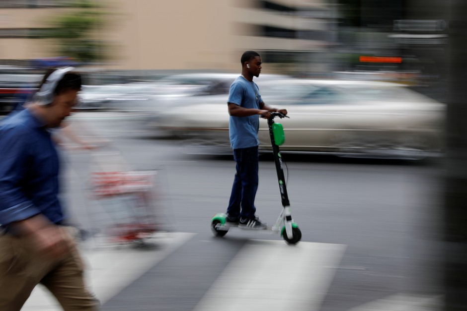 A man rides an electric scooter in Los Angeles.