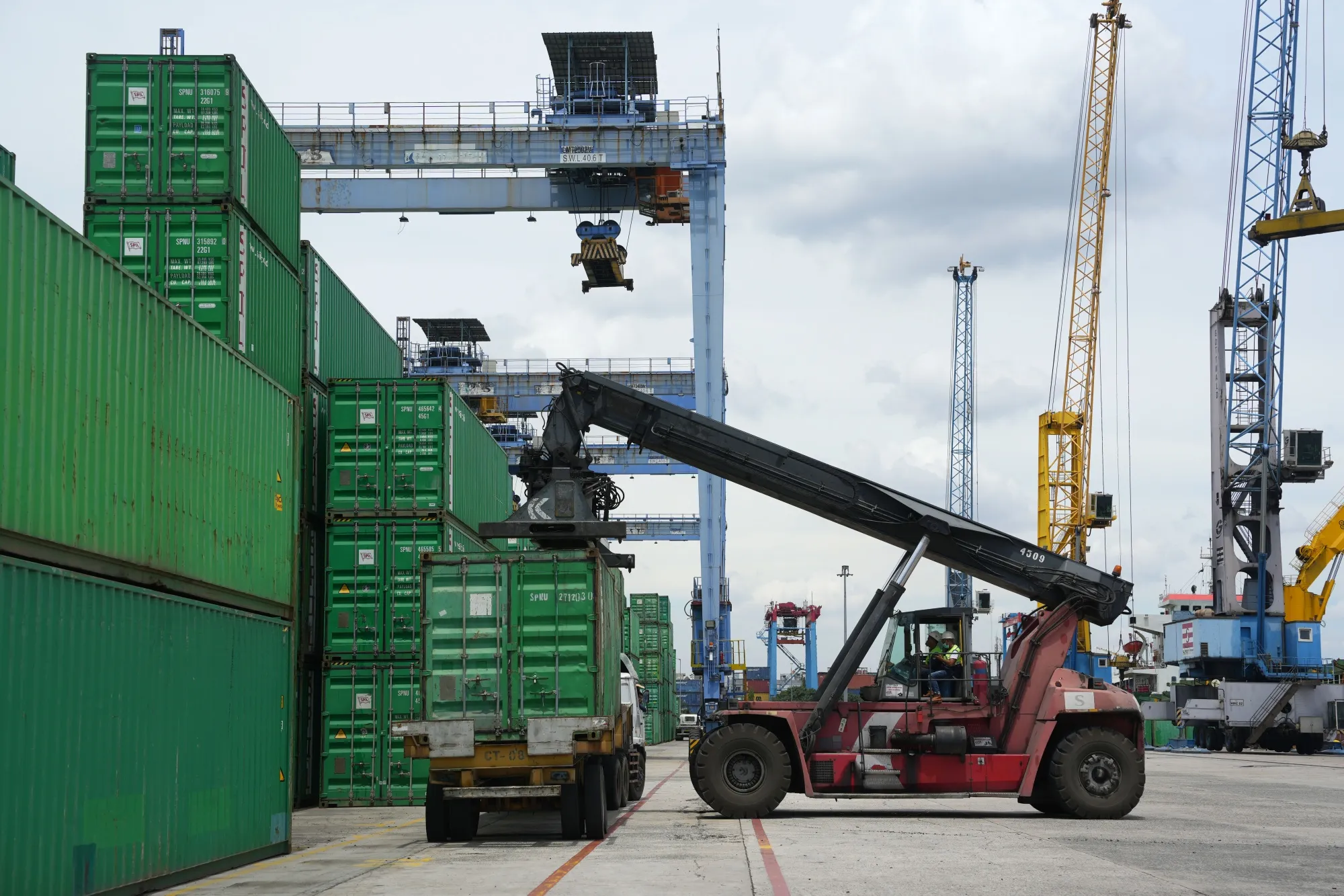 A reach stacker moves a shipping container in the IPC Container Terminal at Tanjung Priok Port in Jakarta, Indonesia..