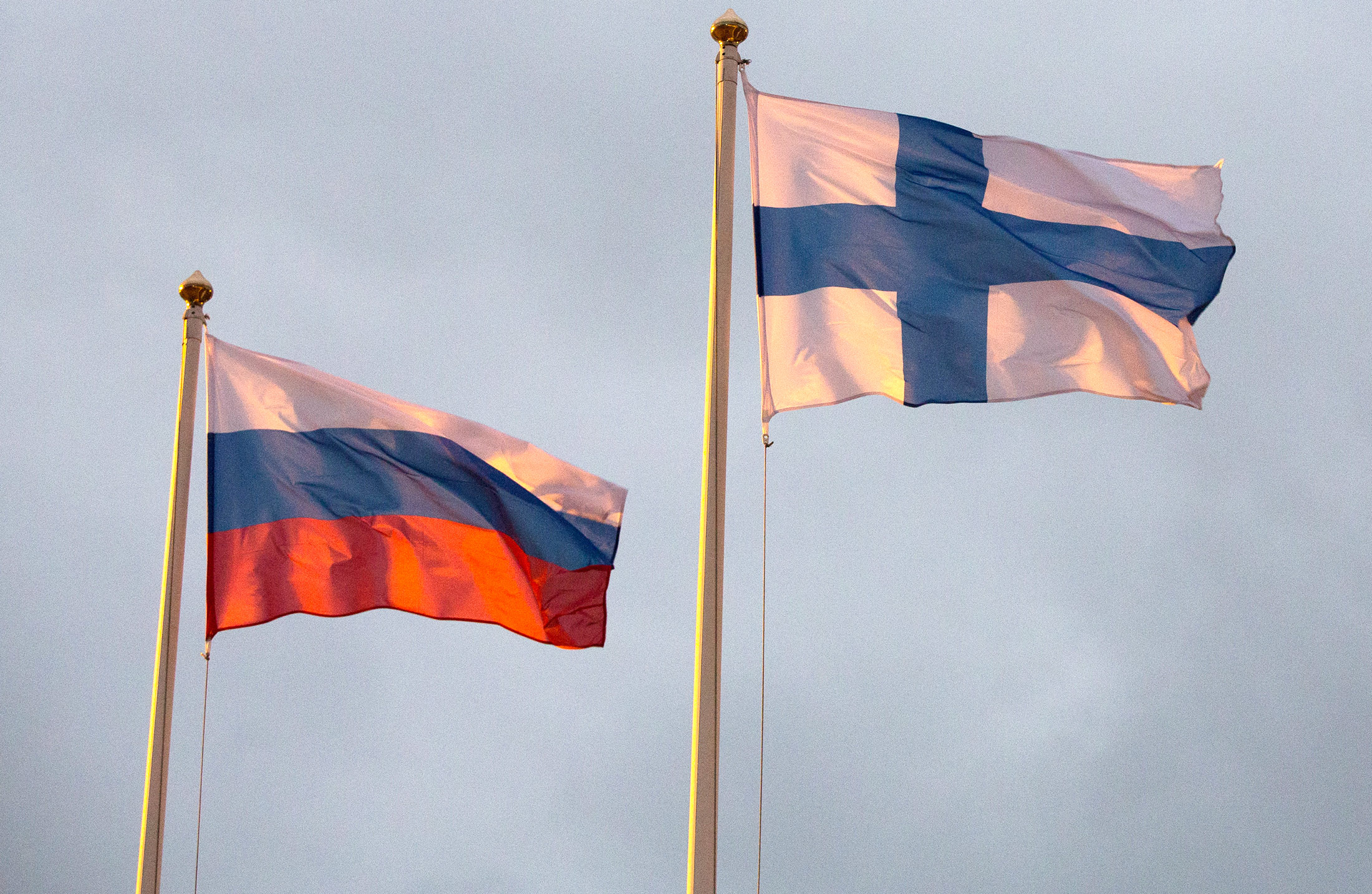 The flags of the Russian Federation, left, Finland.
