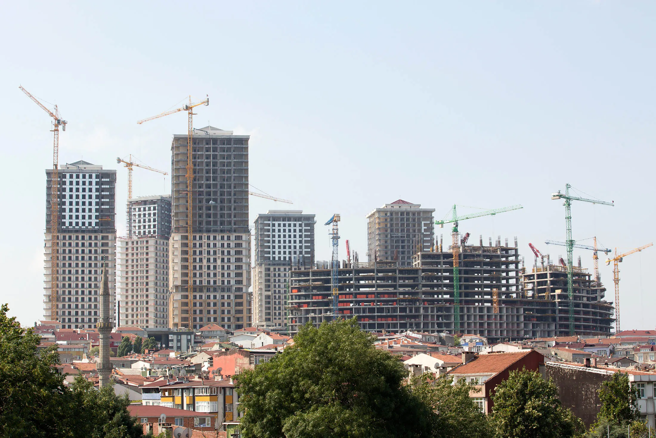 Construction cranes operate around a building project as part of the Venedik Saraylari residential and business area beside the Trans Europe Motorway (TEM) in Istanbul, Turkey, on Wednesday, Aug. 6, 2014. A victory for Turkish Prime Minister Recep Tayyip Erdogan as the first directly elected president in Turkey's history on Aug. 10 would allow him to control the National Security Council and decide on the use of military power while keeping a grip on the government run by his party.
