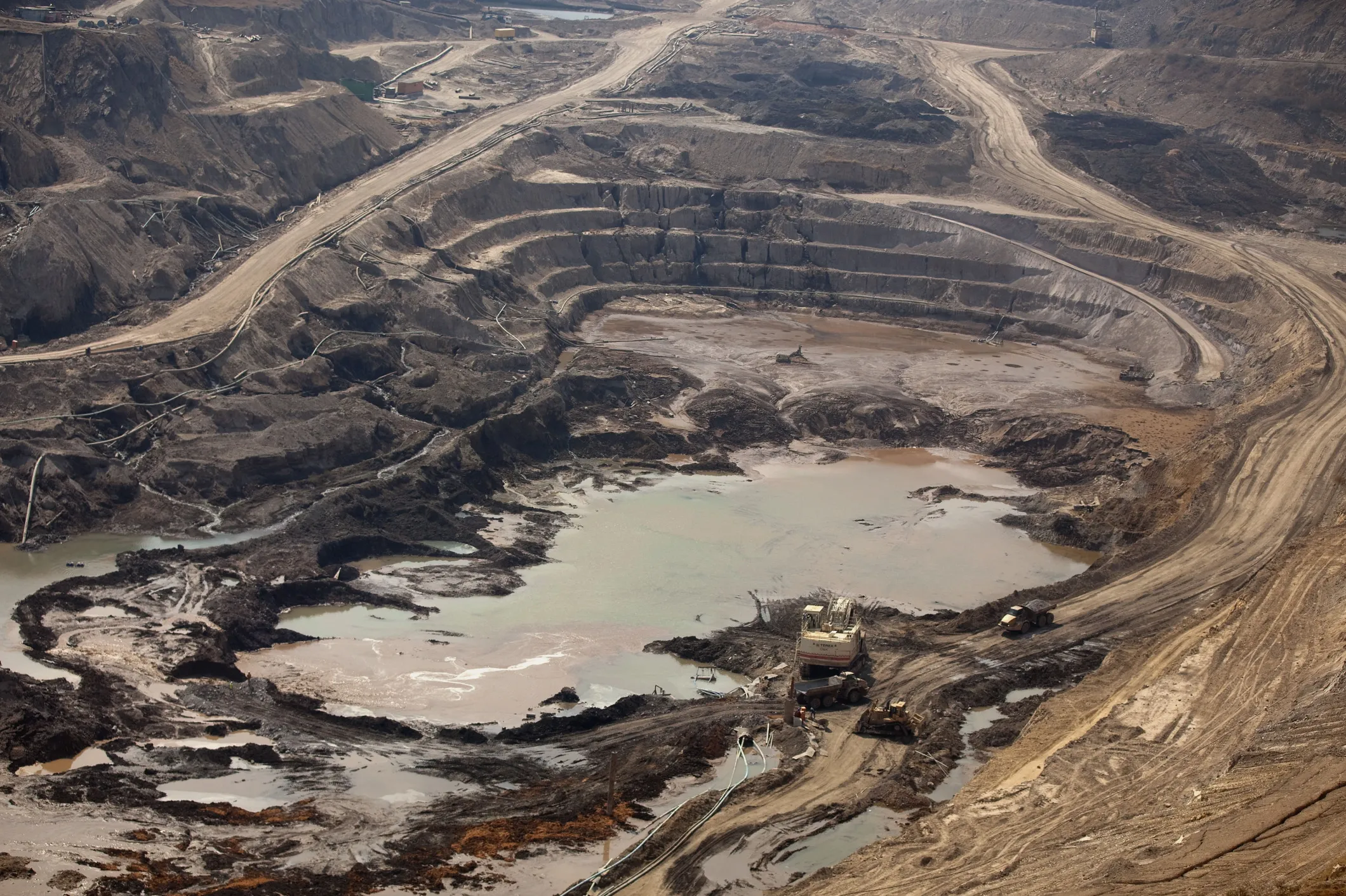 Workers operate digging equipment in an open pit during the excavation of ore at a copper and cobalt mine in Democratic Republic of Congo.