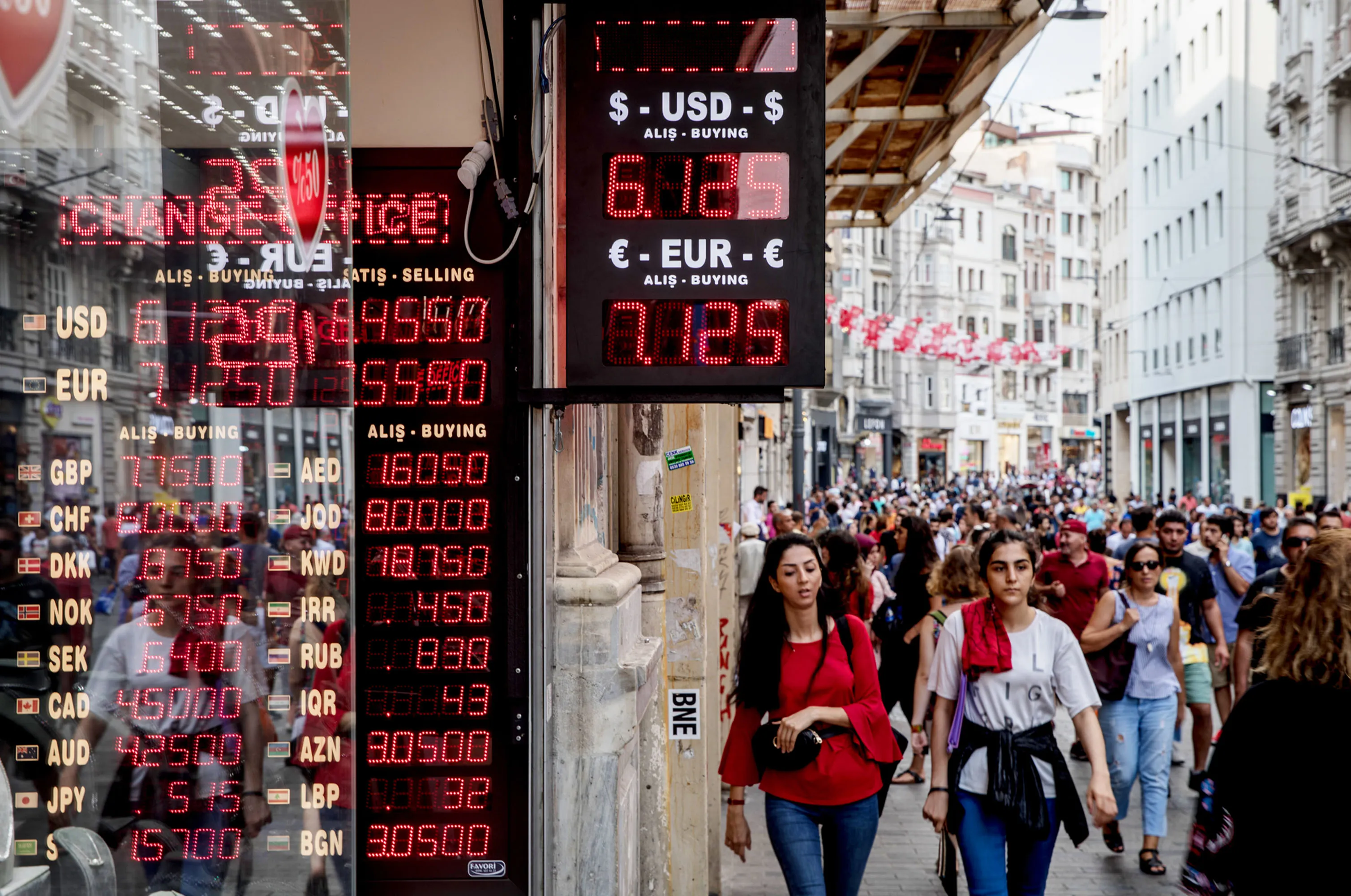 People walk past a currency exchange office&nbsp;in Istanbul.