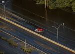 A car drives through flood waters along interstate 95 after Hurricane Matthew hit Lumberton, North Carolina on Monday.