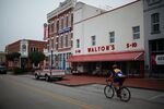 A biker rides past&nbsp;the Walmart Museum's Walton's 5 &amp; 10 in Bentonville, one of several cities in the Northwest Arkansas metro area.&nbsp;