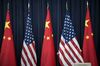 A staff member adjusts an American flag before the opening session of the U.S. and China Strategic and Economic Dialogue, in Washington, D.C.
