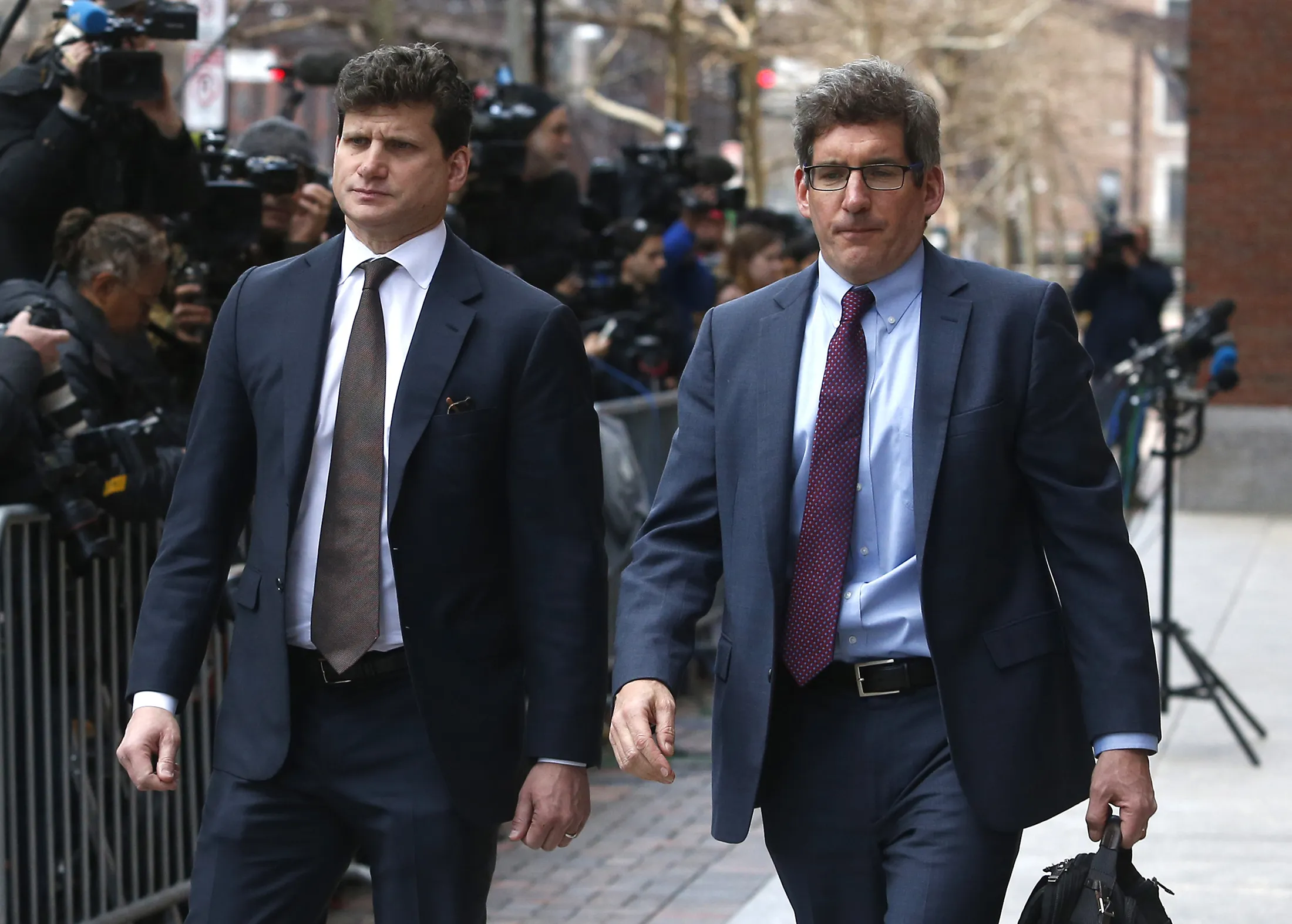 
Gordon Caplan, left, exits the courthouse in Boston.
