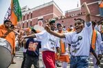 Supporters dance and wave Bharatiya Janata Party flags while celebrating at the party's headquarters in New Delhi on May 23, 2019.