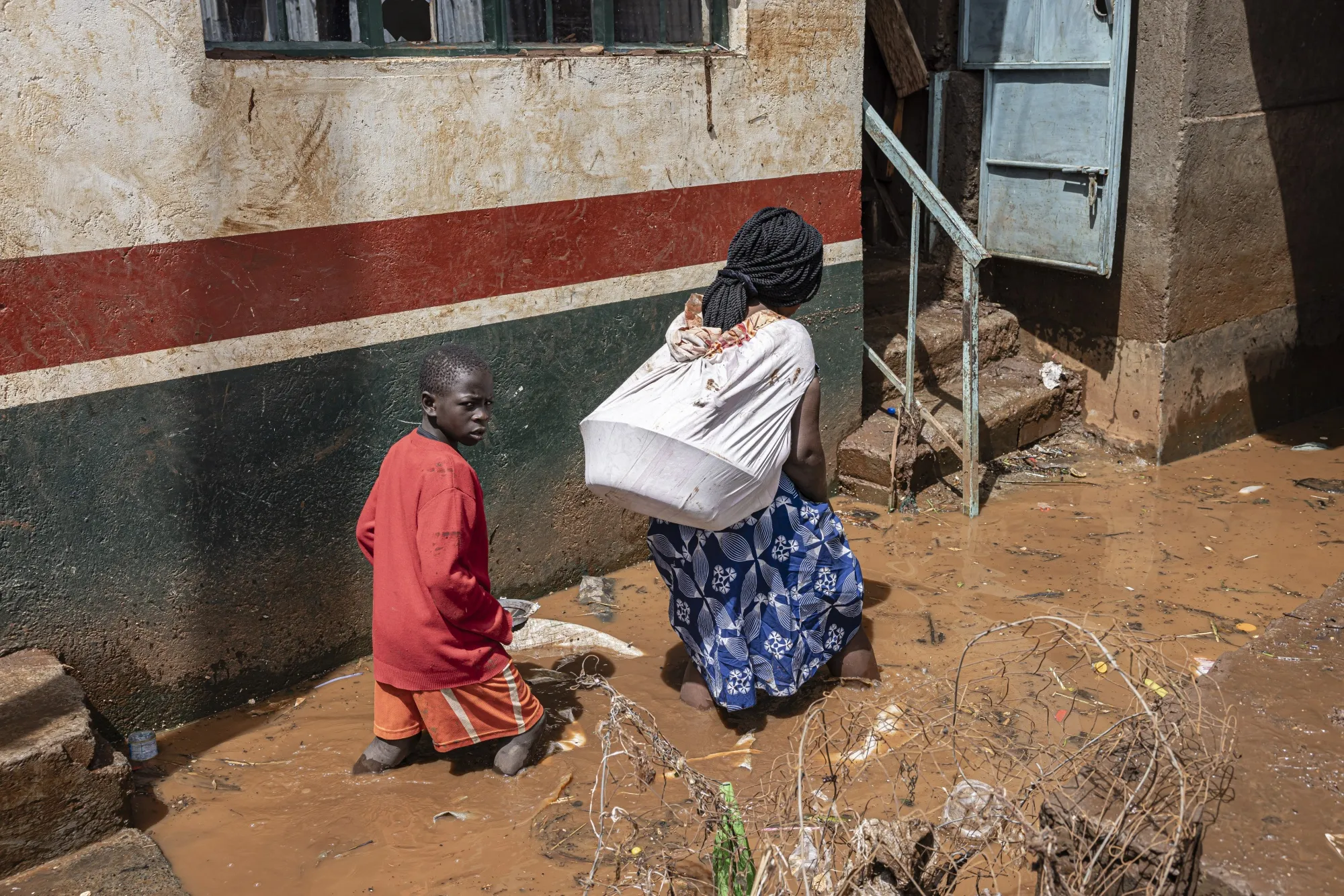 Residents wade through floodwaters following heavy rains&nbsp;in Nairobi, Kenya, in April 2024.&nbsp;