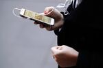 A woman uses a smartphone in Sydney, Australia.