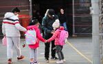 Children greet each other as they arrive at school in New York, on&nbsp;March 7.