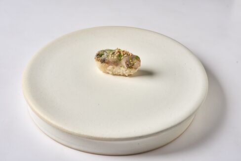 For one of his signature pieces of sushi, Yoshida softens the strong flavors of horse mackerel with shiso, scallions, and ginger.