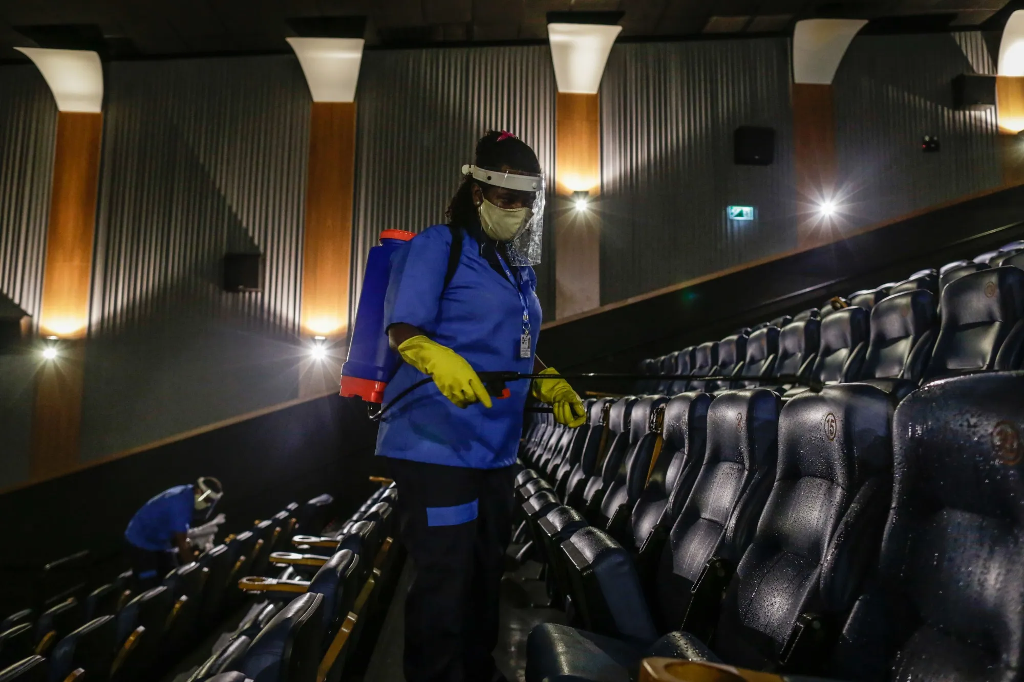 An employee disinfects seats at a movie theater in Rio de Janeiro.&nbsp;
