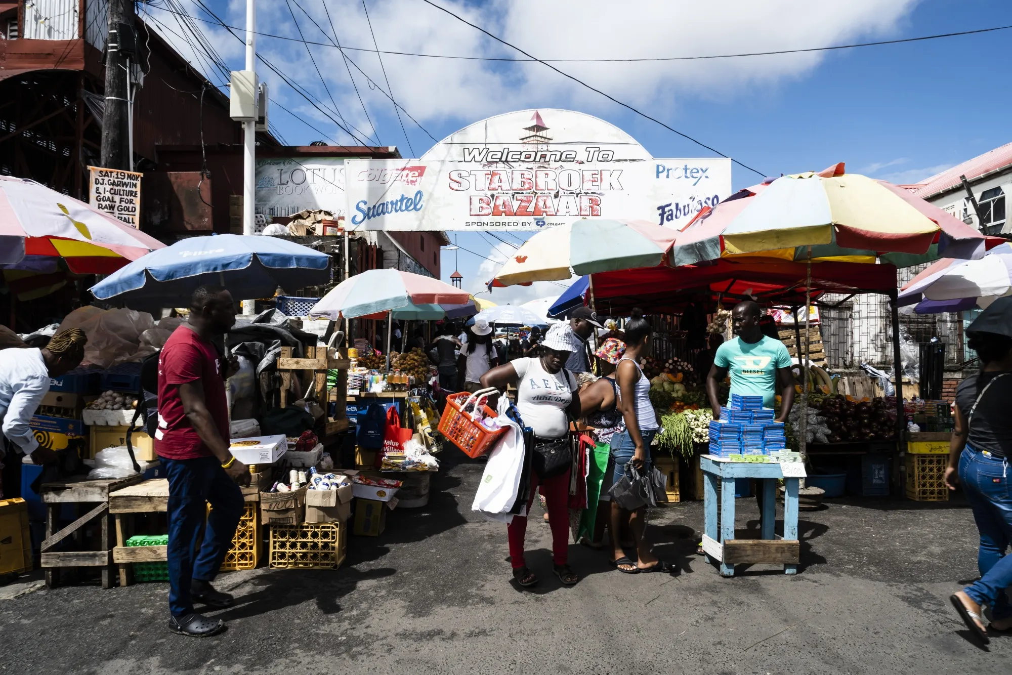 Shoppers walk past vendors at the Stabroek Market in Georgetown, Guyana.