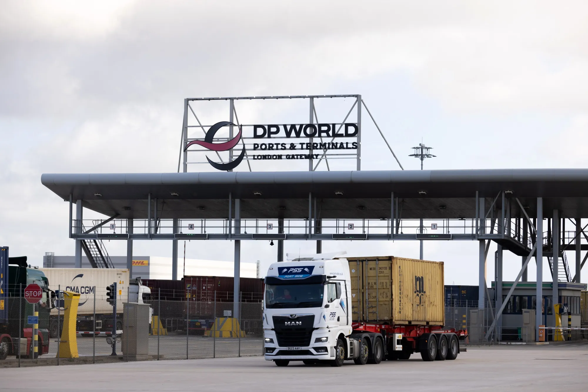 A truck carrying a shipping container leaves London Gateway port, operated by DP World.