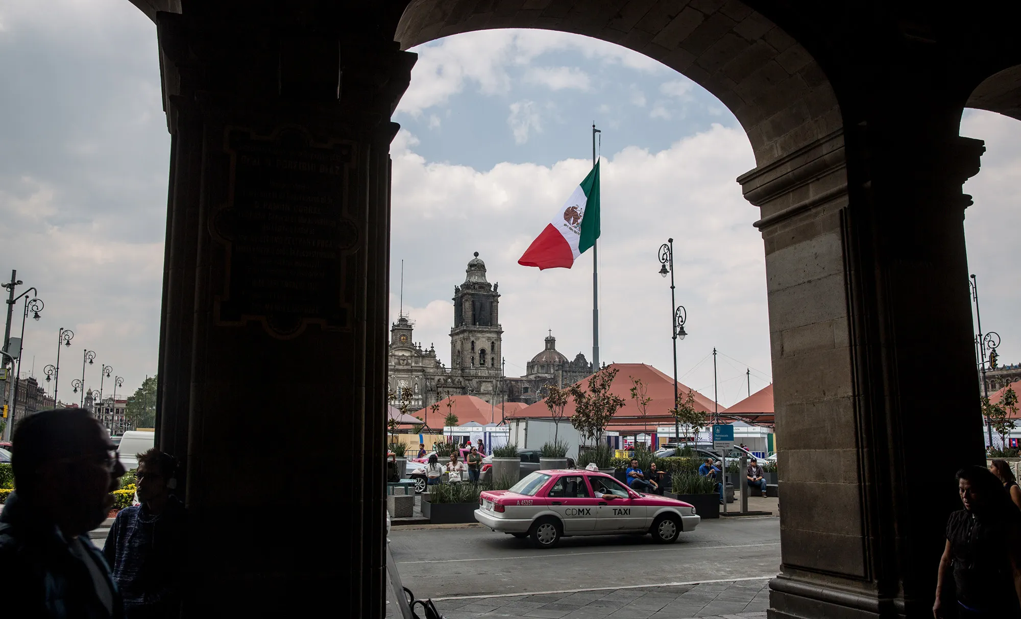 A taxi cab passes in front of&nbsp;the Plaza de la Constitucion (Zocalo) in Mexico City.
