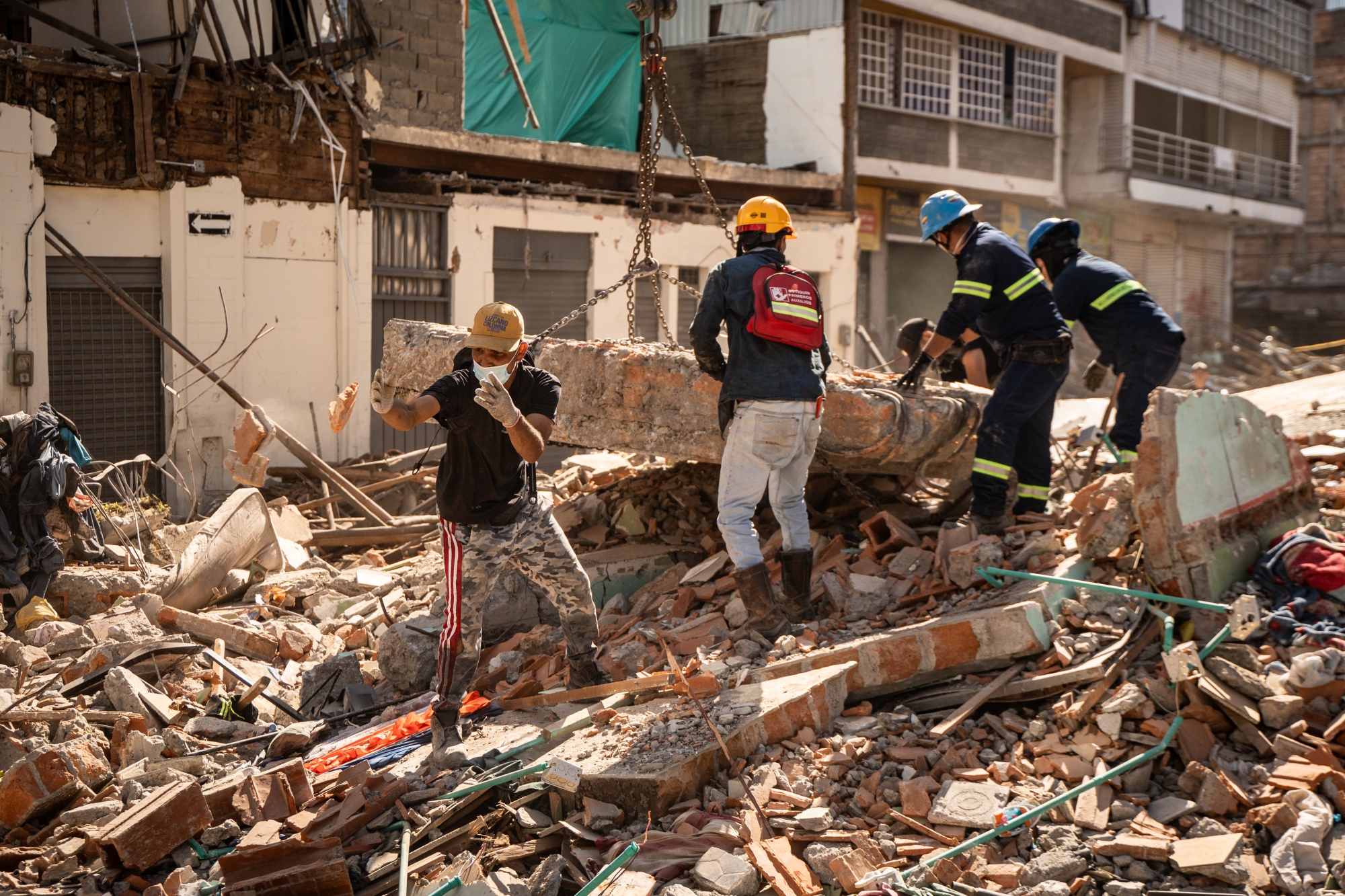 Rescue workers and volunteers clear debris