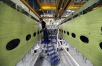 An employee inspects a wingbox section for an Airbus SAS aircraft at GKN Plc’s Aerospace factory in Filton, U.K.