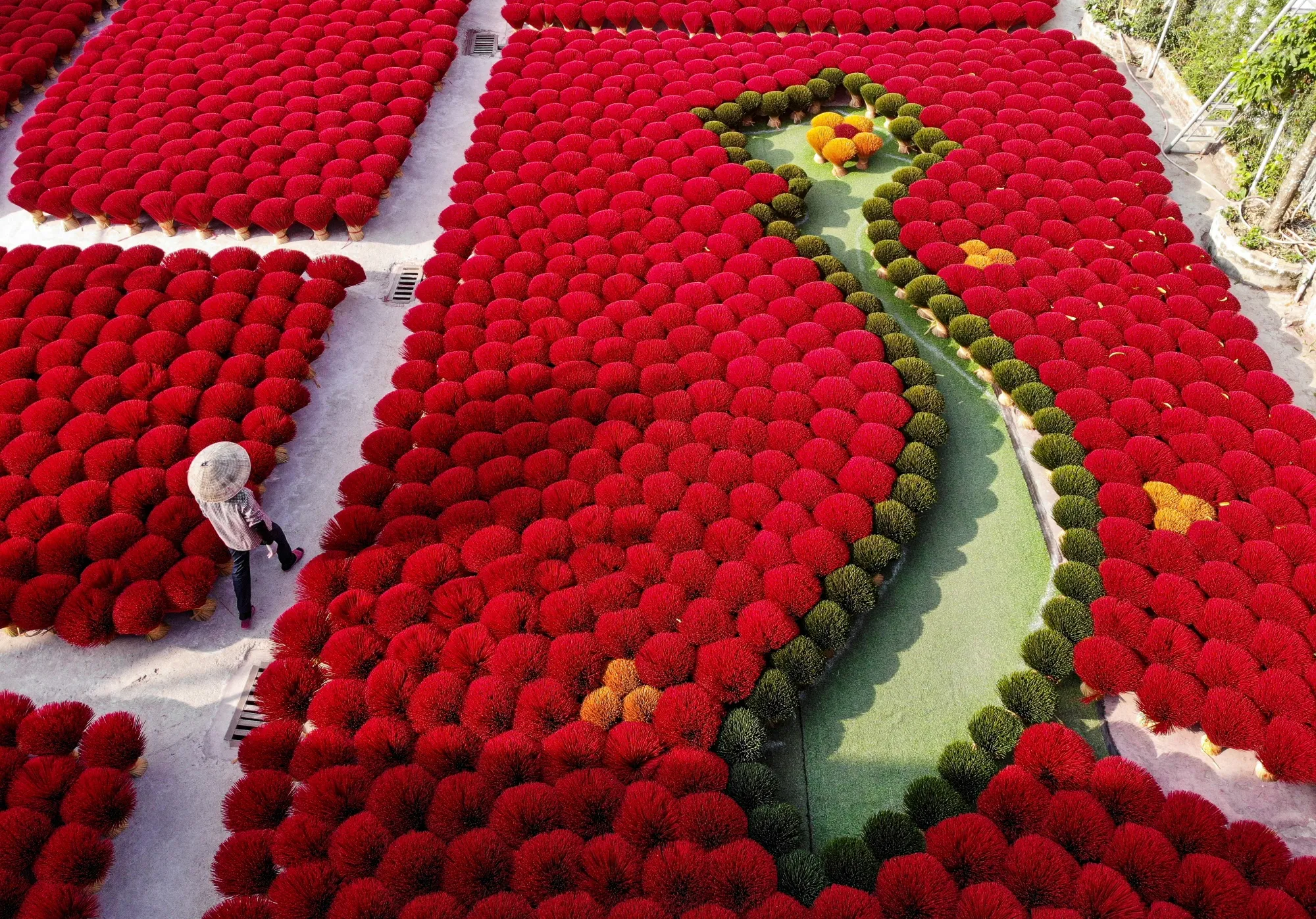 A silhouette of Vietnam in a field of&nbsp;red incense sticks.