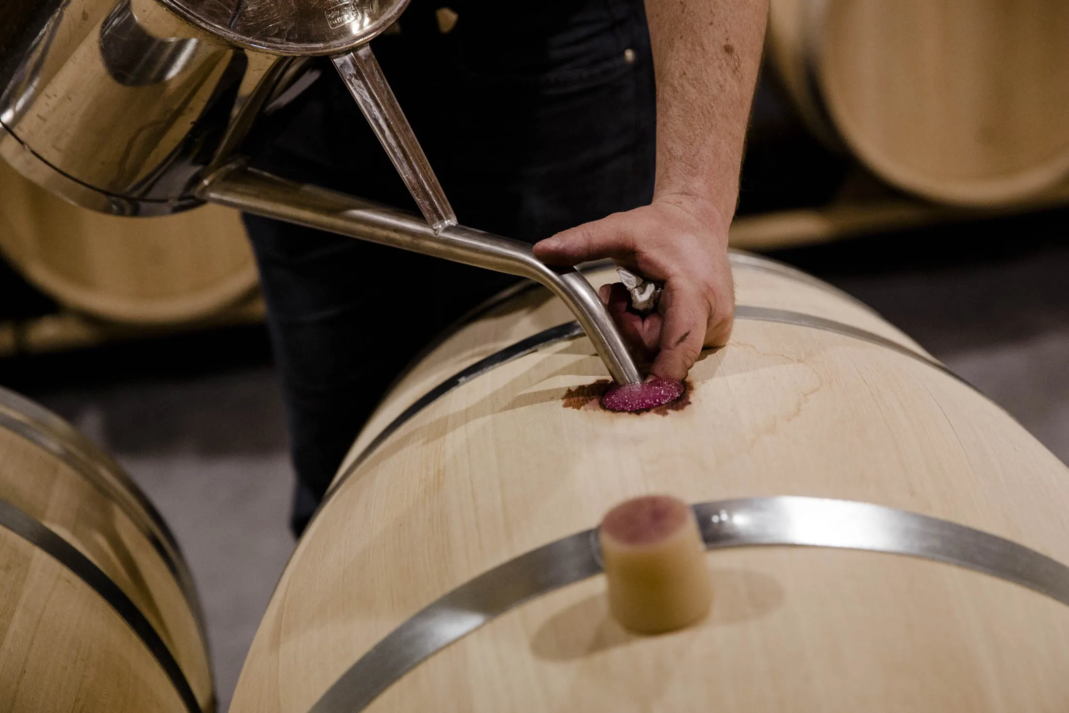 The cellar master as he's topping up the wines to avoid any contact between the wine and the air.
