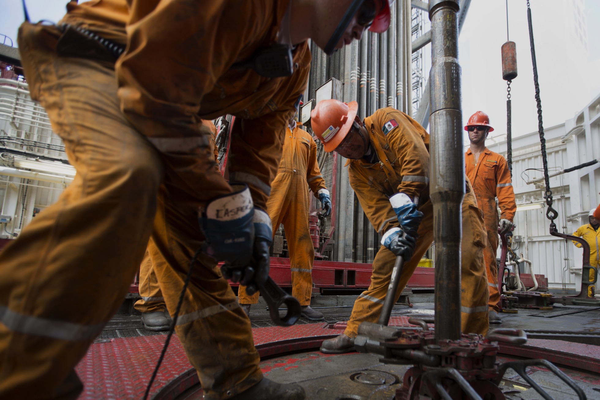 Workers prepare drilling pipe on a crude oil platform in the waters off of Veracruz, Mexico.