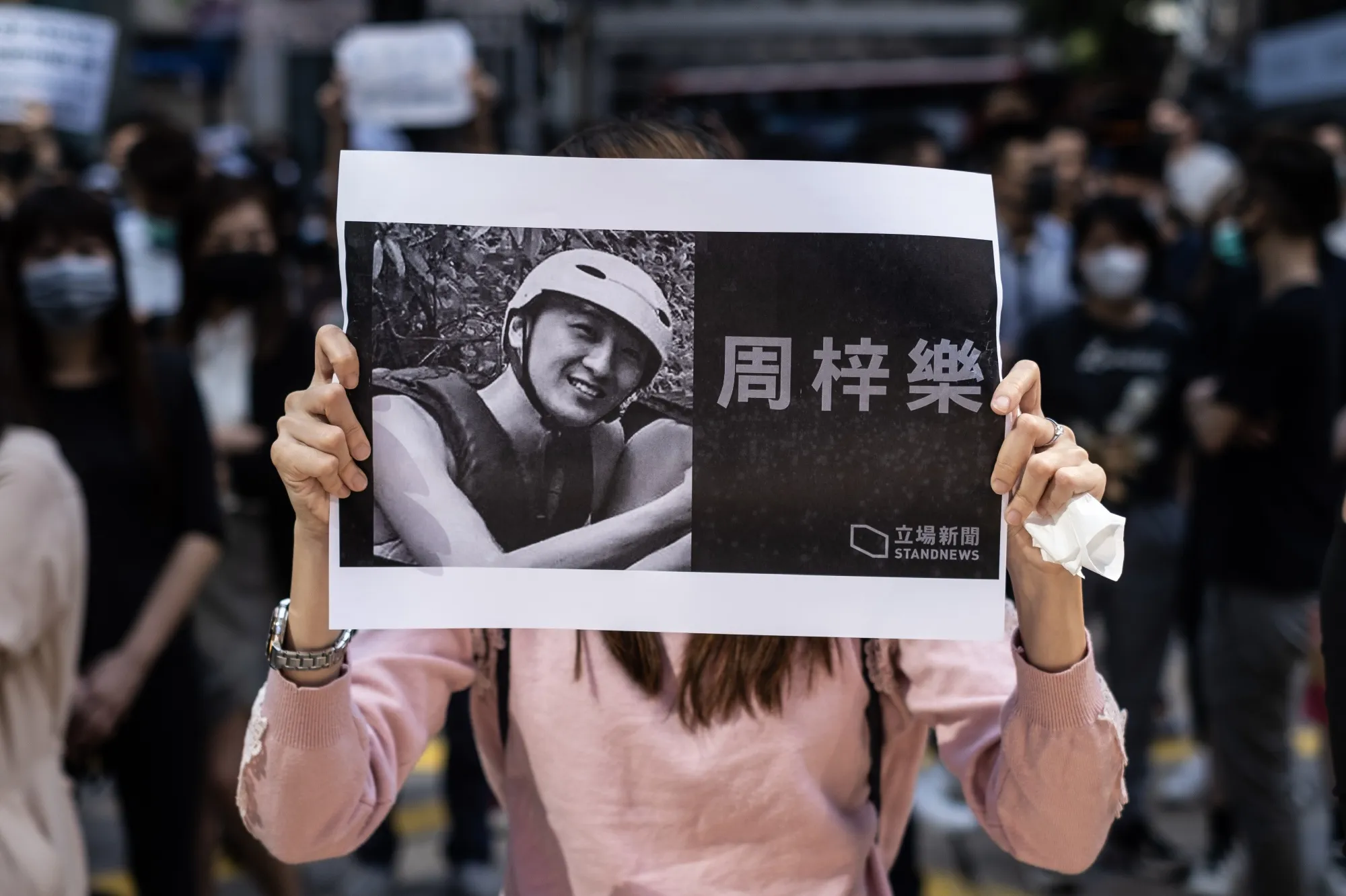 A demonstrator holds a placard featuring Chow Tsz-lok on Nov. 8.