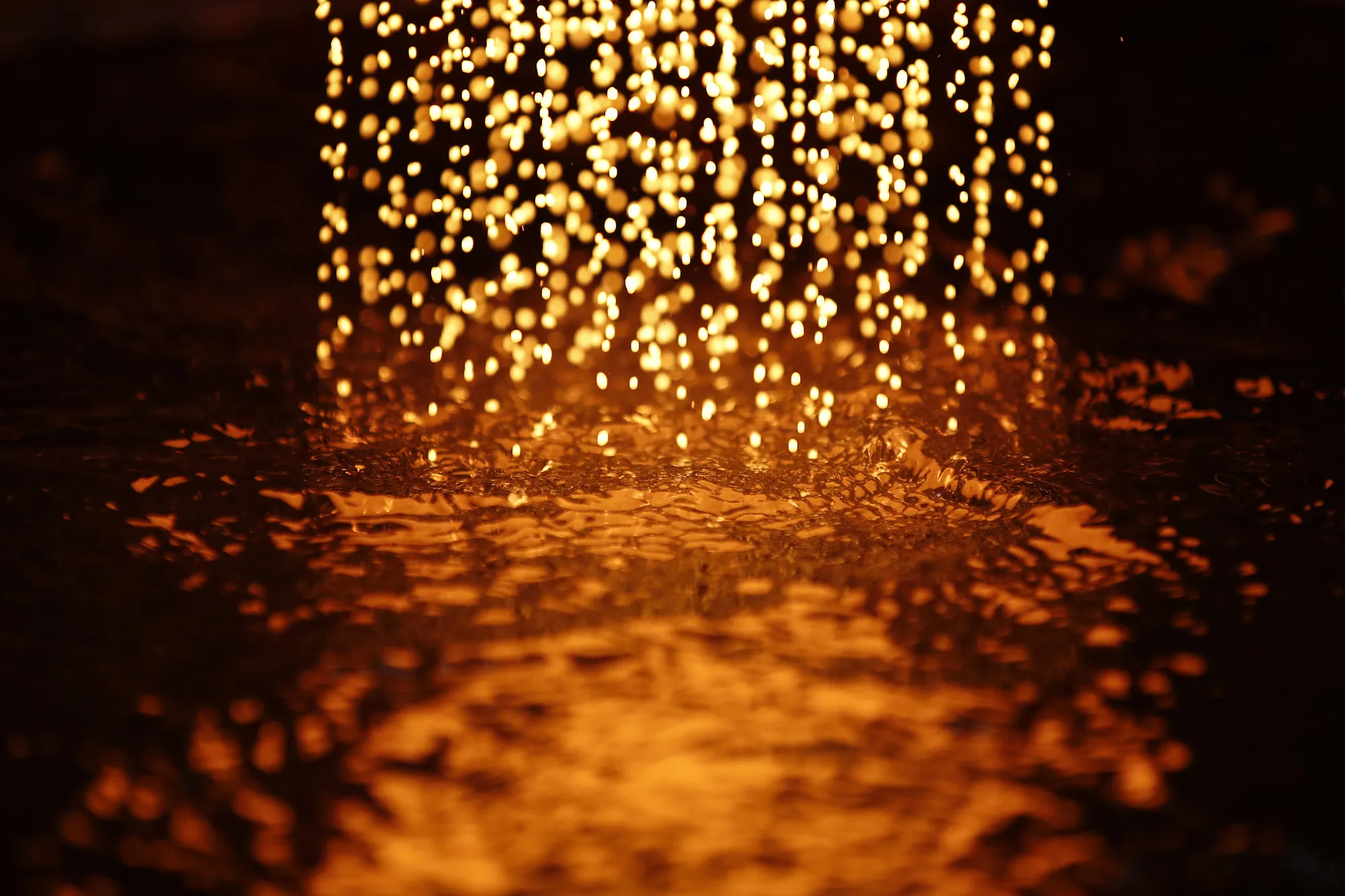 Molten gold hits the surface of the water to cool and produce gold casting grain during the refining process at the Valcambi SA precious metal refinery in Balerna, Switzerland.
