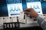 A person picks up a Juul Labs Inc. device kit&nbsp;in San Francisco.