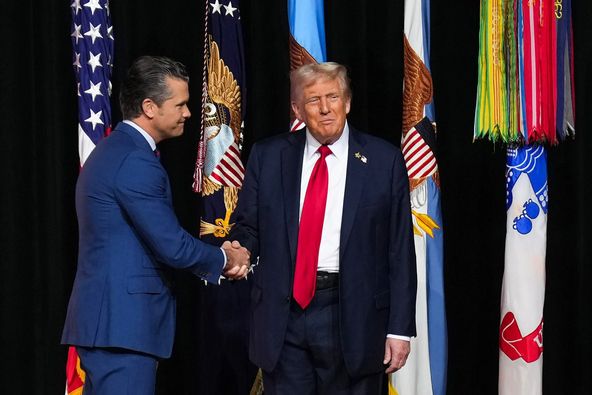 US President Donald Trump and Defense Secretary Pete Hegseth shake hands at Marine Corps Base Quantico.
