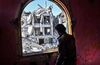 A member of the Syrian Democratic Forces looks out from a building at the frontline in Raqa on Oct. 16, 2017.