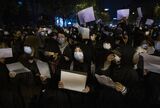 Protesters hold up a white piece of paper during a protest in Beijing on Nov. 27.