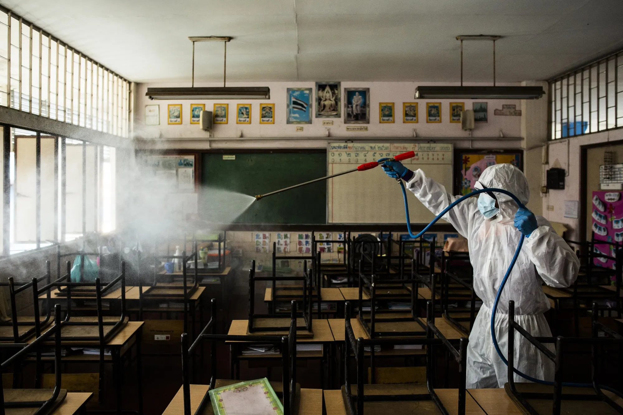 A Bangkok Metropolitan Authority employees disinfects a classroom during a cleaning day at San Chao School in Bangkok, Thailand.