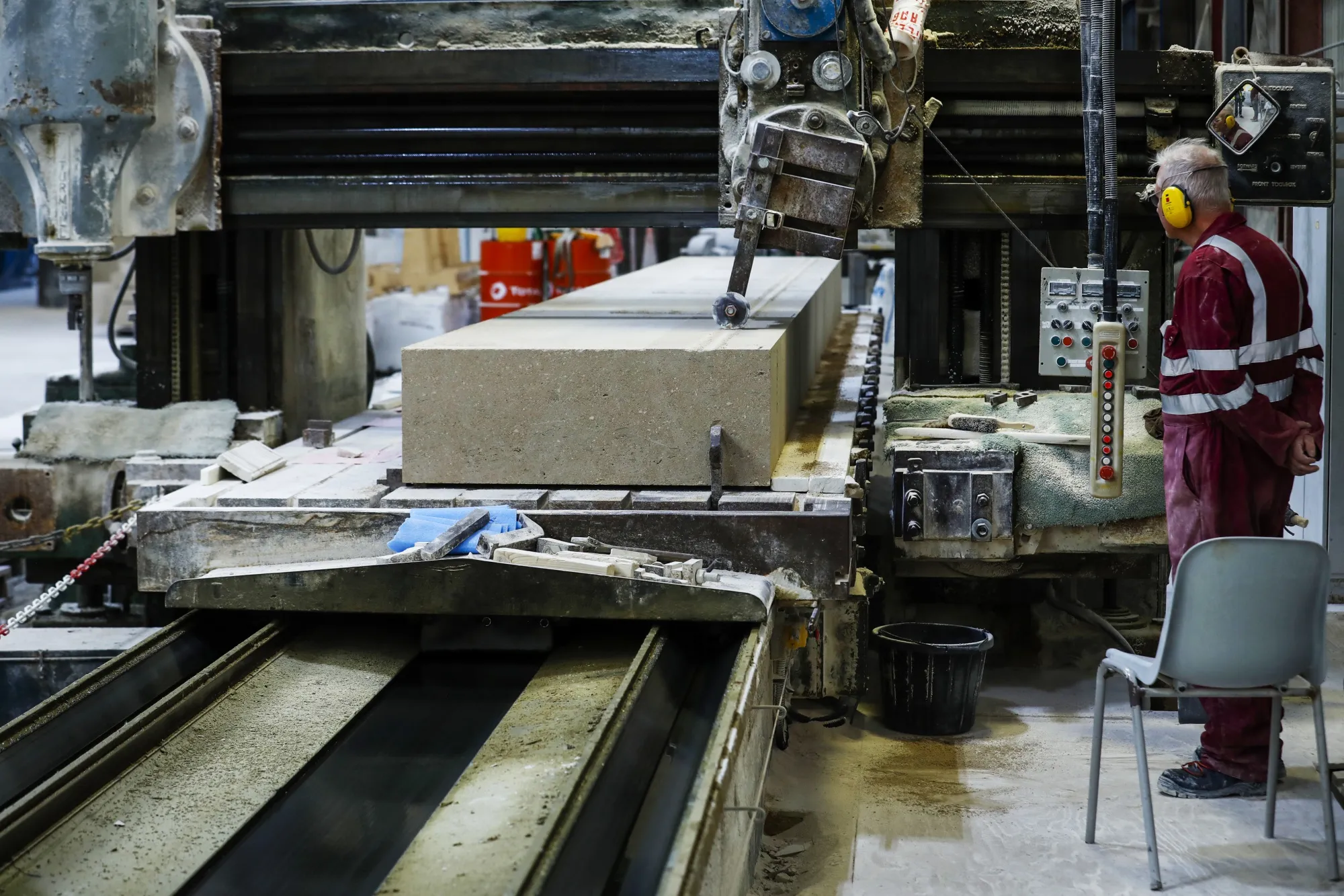 Limestone enters the planing machine at Albion Stone at Portland near Weymouth, U.K.