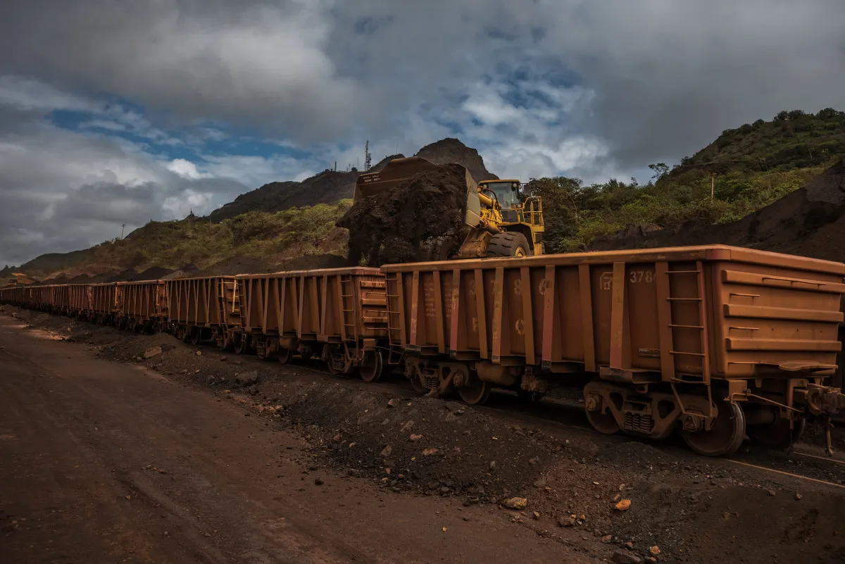 A bulldozer loads iron ore into train cars at the CVG Ferrominera Orinoco mine outisde of Ciudad Piar, Venezuela.