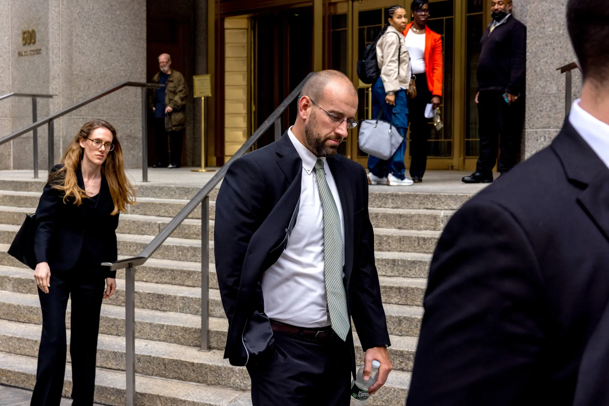 Scott Becker, former chief risk officer of Archegos Capital Management, center, exits federal court in New York in&nbsp;2024.