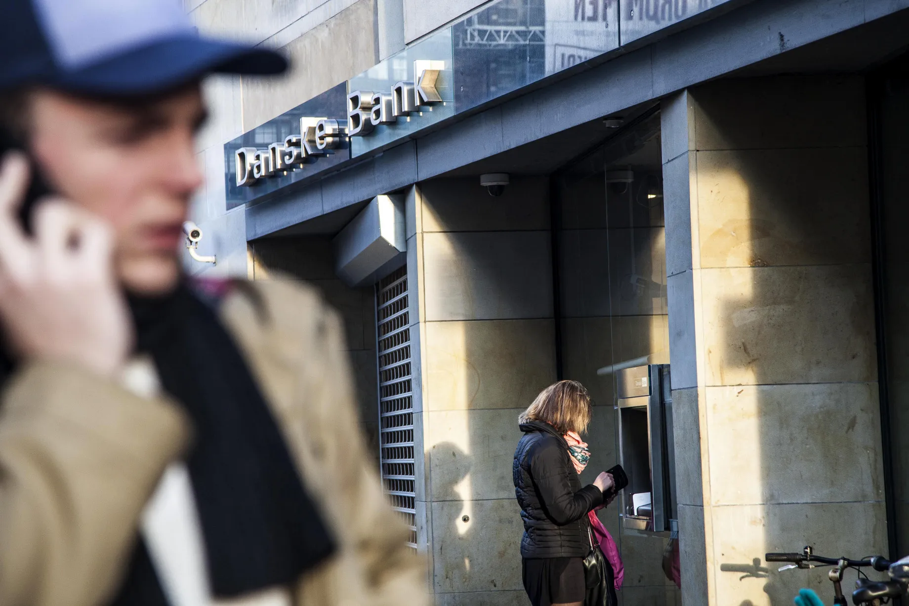 A customer uses an ATM&nbsp;outside a Danske Bank A/S bank branch in Copenhagen, Denmark.