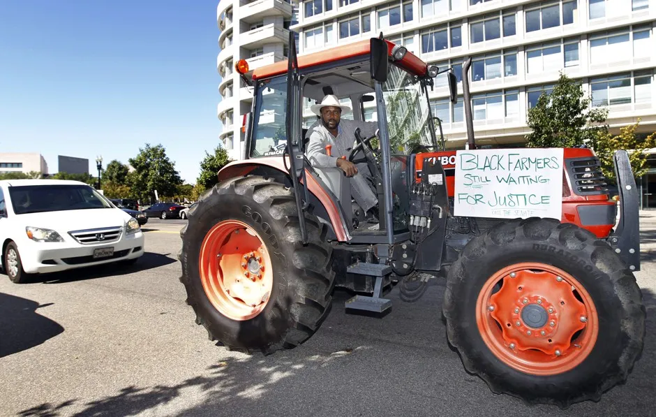 Farmer John Boyd drives his tractor "Justice" near the the Capitol building in Washington, D.C. and calls on lawmakers to pass a bill to address injustices to black farmers.