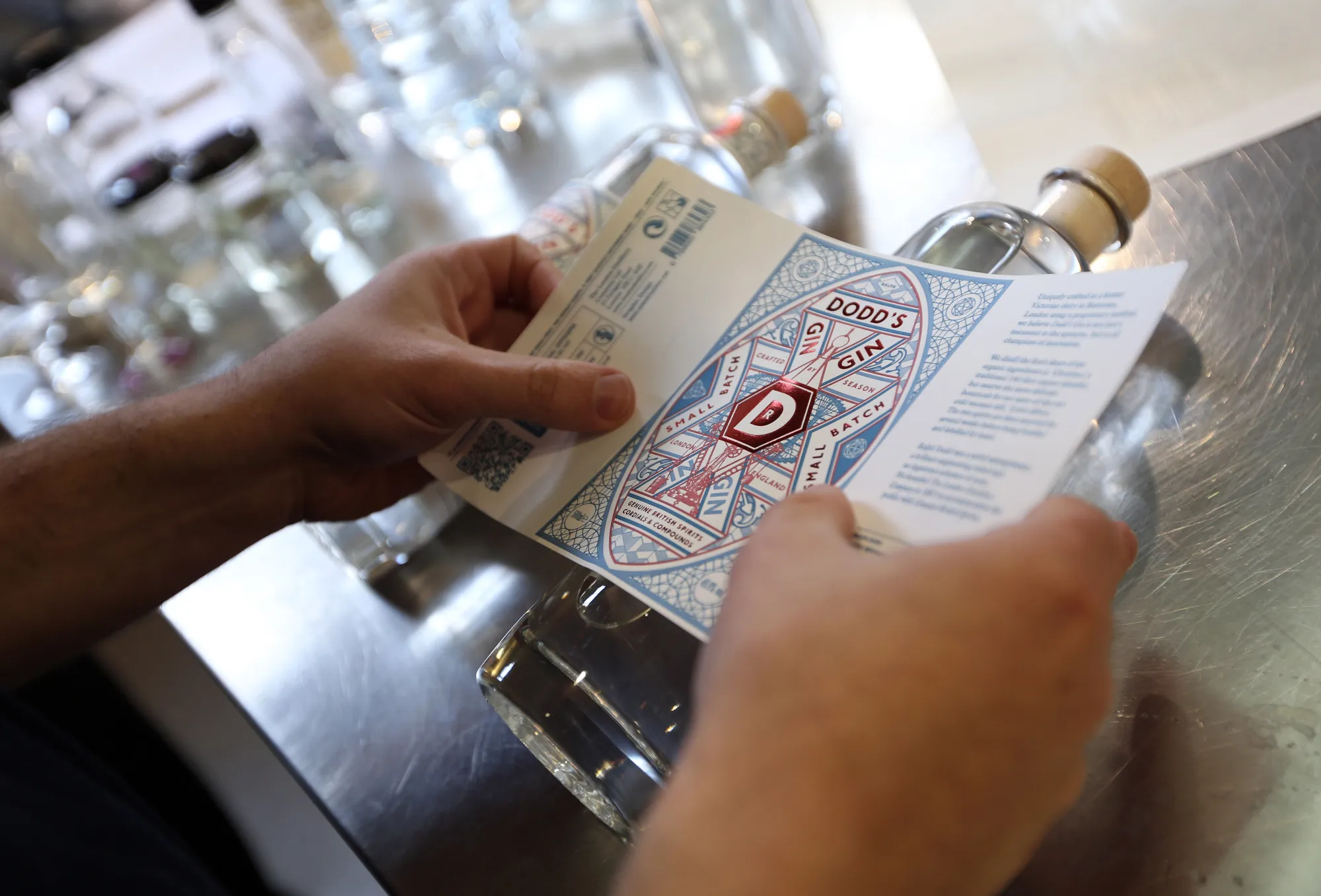 An employee places a label on a bottle Dodd's gin, produced in London.