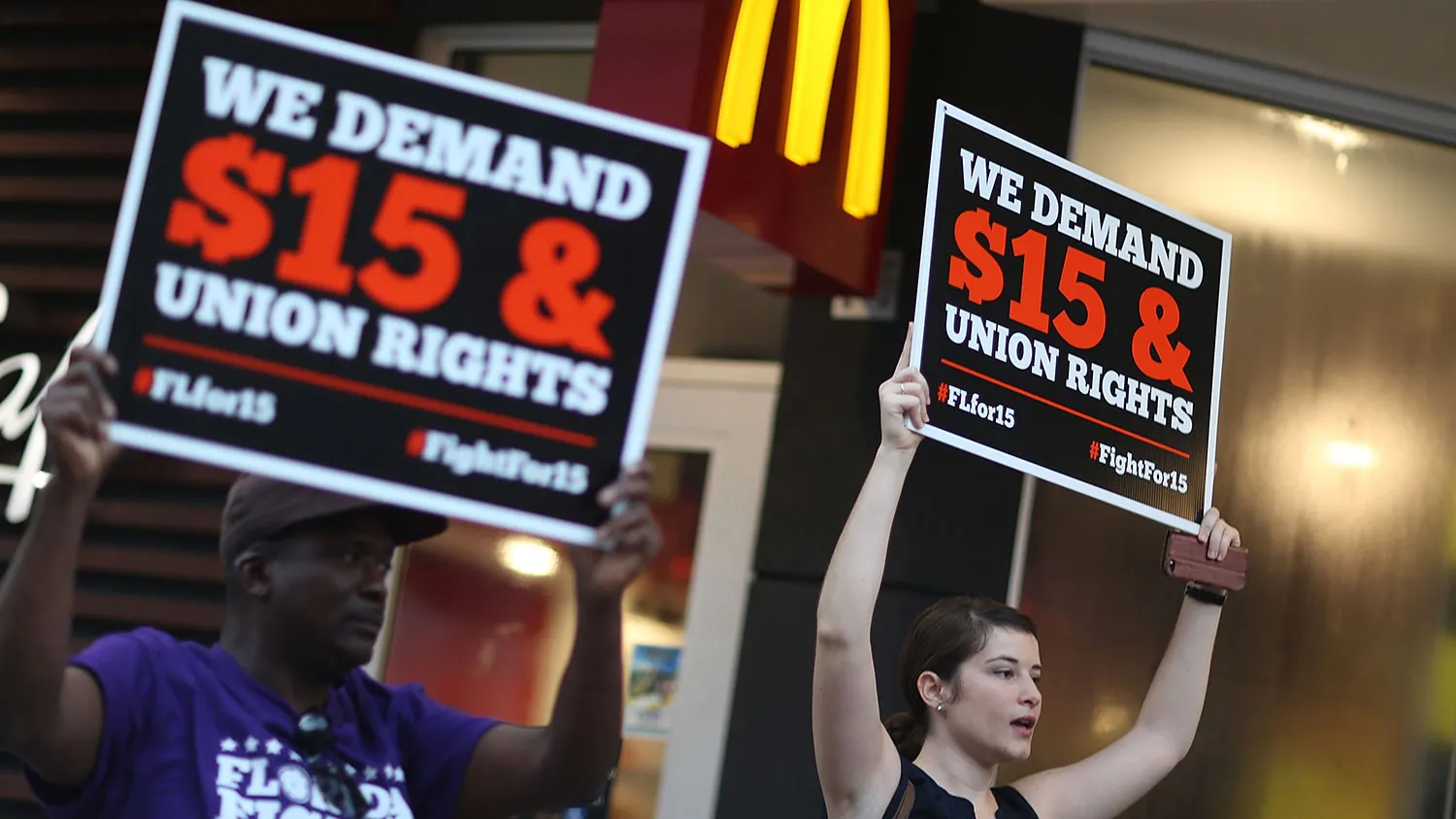 People protest outside a McDonald's restaurant on Nov. 10, 2015 in Miami.
