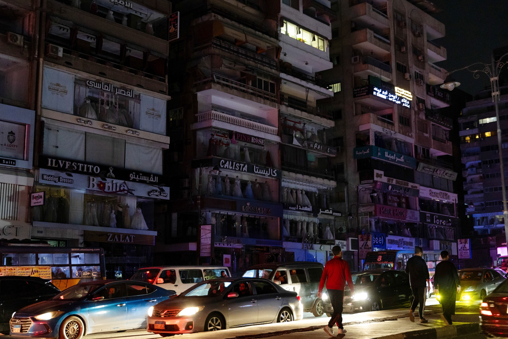 Traffic on a street where lights have been switched off and stores have closed early to conserve energy in Cairo, Egypt, on Sunday, March 29, 2026. Egypt began curbing some electricity use, including by ordering shops and cafes to close earlier, as the North African energy importer grapples with soaring global fuel costs caused by the Iran war.